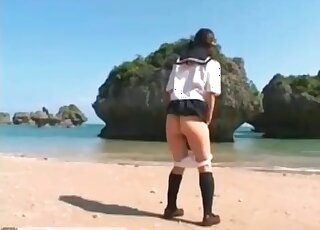 Outdoors shitting on the beach with an Asian teen